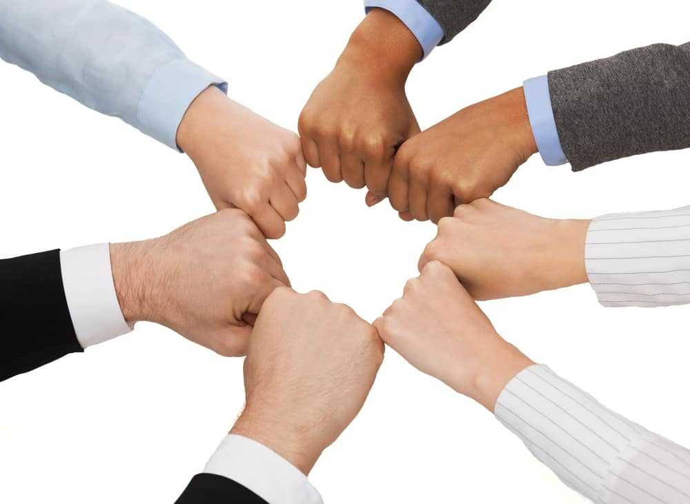 Motivation-fist-in-circle-teamwork-motivate-to-lead