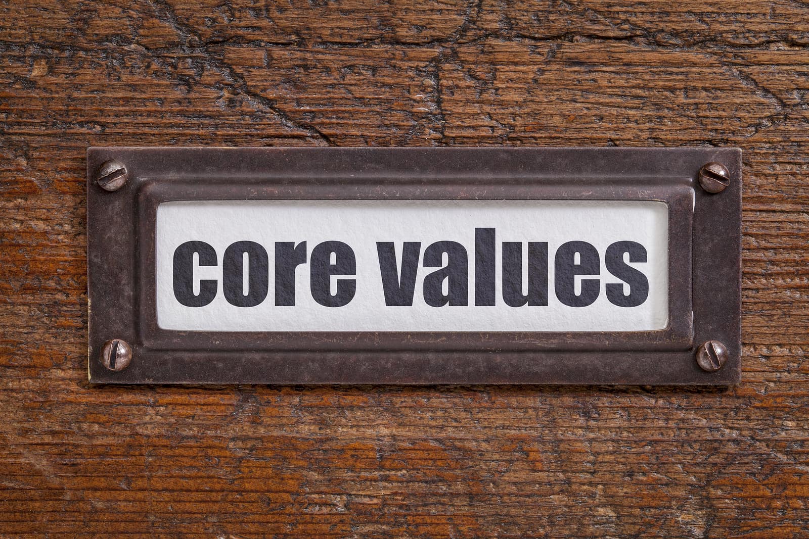Core values tag on file cabinet label with bronze tag frame