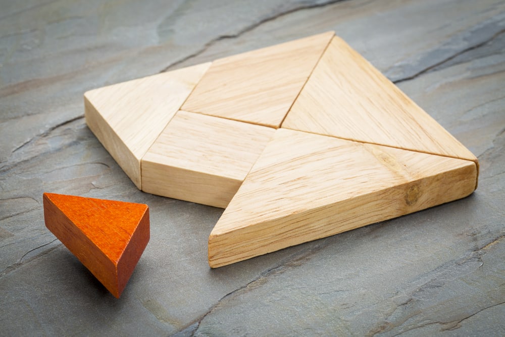 Wooden puzzle illustrating the missing piece to the question, do you lead followers or leaders? 