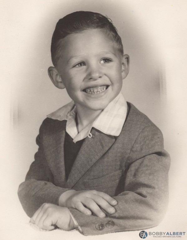 Boyhood picture of Bobby Albert smiling due to his abundance mindset.